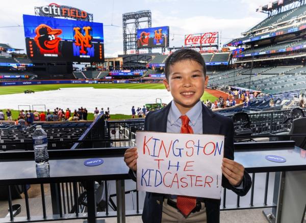 altimore Orioles vs. New York Mets at Citi Field - Kidcaster winner, 9-year-old Kingston Korn from Manhattan, poses for a photo before the start of the game.