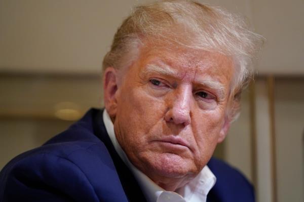 Former President Do<em></em>nald Trump listens as he speaks with reporters while in flight on his plane after a campaign rally at Waco Regio<em></em>nal Airport, in Waco, Texas, March 25, 2023, while en route to West Palm Beach, Fla.
