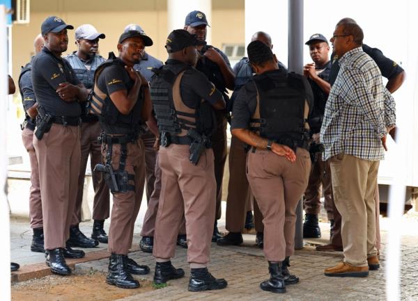 Correctio<em></em>nal service emergency support team members stand at the entrance of the Natio<em></em>nal head offices wher<em></em>e parolees are processed, ahead of Pistorius' release on Jan. 5, 2024. 