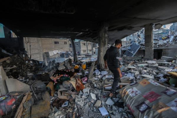 A Palestinian man inspecting damage after Israeli air strikes in Khan Yunis in the Gaza Strip on Dec. 3, 2023.