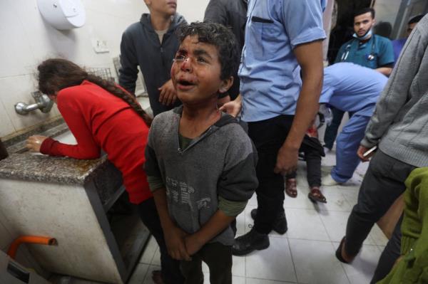 A Palestinian boy crying after being brought to Nasser hospital after an air strike on Dec. 3, 2023.