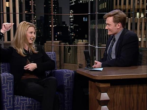 Lisa Kudrow smiling at Co<em></em>nan O'Brien on his show. 