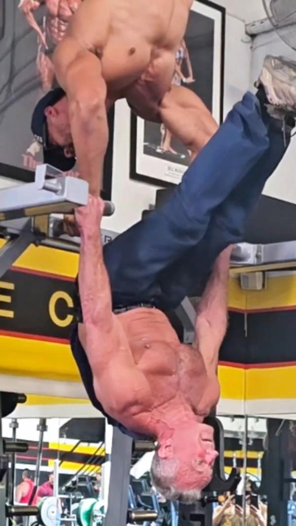 Kennedy performed a tricky pull-up rollover with his workout partner performing a handstand above him.