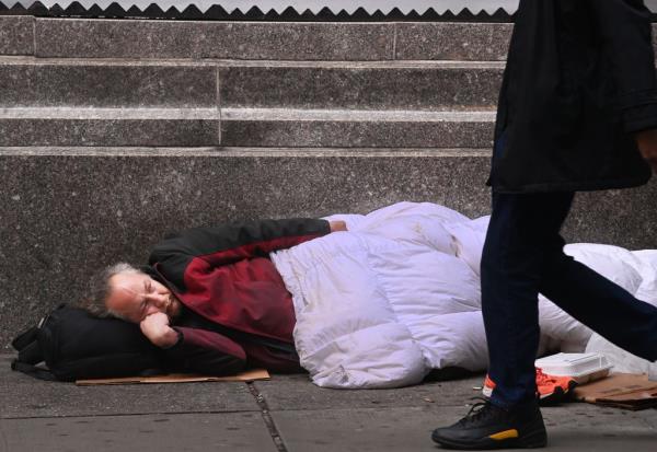 For News:12-27-2023:Homeless:New York-Homeless man sleeps next to a subway at Herald Square.