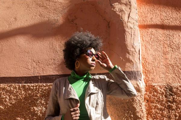 woman standing on a wall in the medina and looking to the right