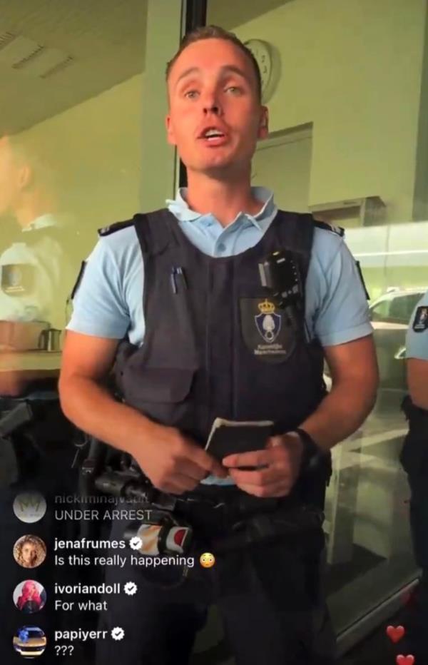 Nicki Minaj in Amsterdam involved in a dispute with a police officer, adamantly refusing to enter police vehicle before a lawyer arrives
