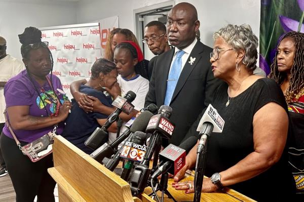 Illinois state Sen. Doris Turner, D-Springfield, speaks to reporters while family members of So<em></em>nya Massey comfort one another in Springfield, Ill. on Monday, July 22, 2024. 