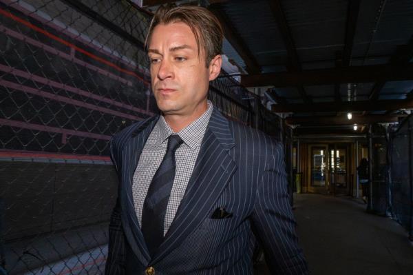 Michael Gancarz, owner of Chelsea Wine Co., in a suit, after being arrested for allegedly stealing wine