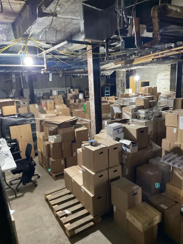 A room with boxes stacked on pallets in the Gancarzes' wine storage business located in a ba<em></em>sement space in Midtown Manhattan