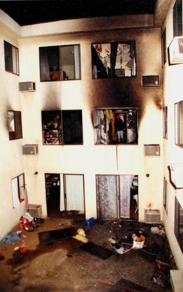 In this May 1993 photo provided by the Los Angeles Police Department, on display at a news conference, investigators attend the scene of a deadly fire that struck an apartment building in the Westlake district of Los Angeles