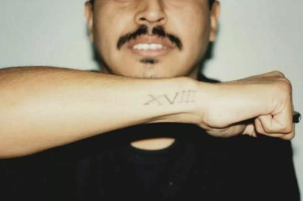 Juan Romero, shown here displaying his 18th Street tattoo