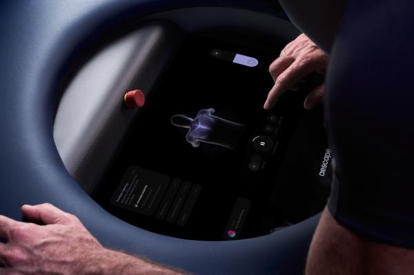 A person interacting with a touchscreen for a customized Aescape massage