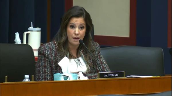 Elise Stefanik sitting before a microphone