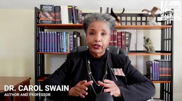 Political scientist Carol Swain sitting in front of a bookcase