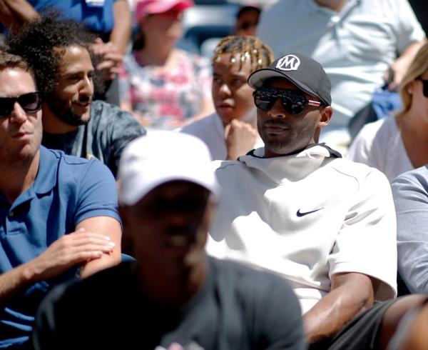 Kobe Bryant, right, and Colin Kaepernick, second from left, watch the second round of the US Open tennis champio<em></em>nships Thursday, Aug. 29, 2019, in New York. 