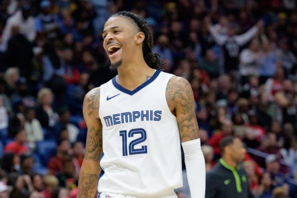 Memphis Grizzlies guard Ja Morant (12) celebrates a score to even the game during the fourth quarter against the New Orleans Pelicans