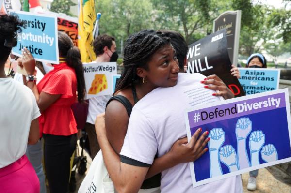People embrace each other as demo<em></em>nstrators for and against the U.S. Supreme Court decision to strike down race-co<em></em>nscious student admissions programs co<em></em>nfront each other, in Washington, U.S., June 29, 2023.