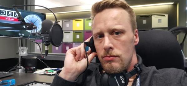 Radio DJ Christopher Blake in a studio.