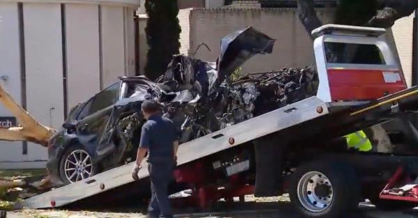 Police tow away Johnson's smashed car.