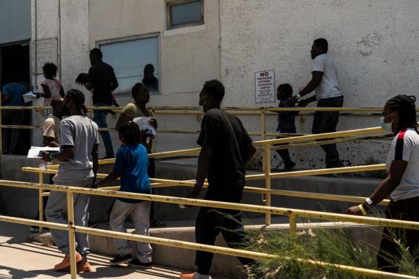 Migrants line up to enter one of the shelters run by Annunciation House.