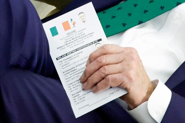 President Biden holds up a cheat card while meeting with the Irish prime minister.