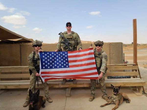 Several military members and dog Yyacob.