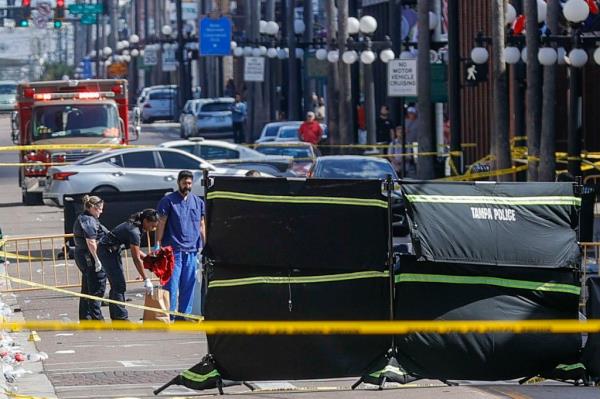 Officials seen at the crime scene following an early morning shooting. 