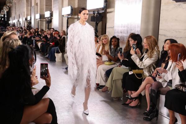 Uma Thurman and Awkwafina sit in the front row during Tory Burch's Fall/Winter 2024 fashion show at the NY Public Library in NYC.