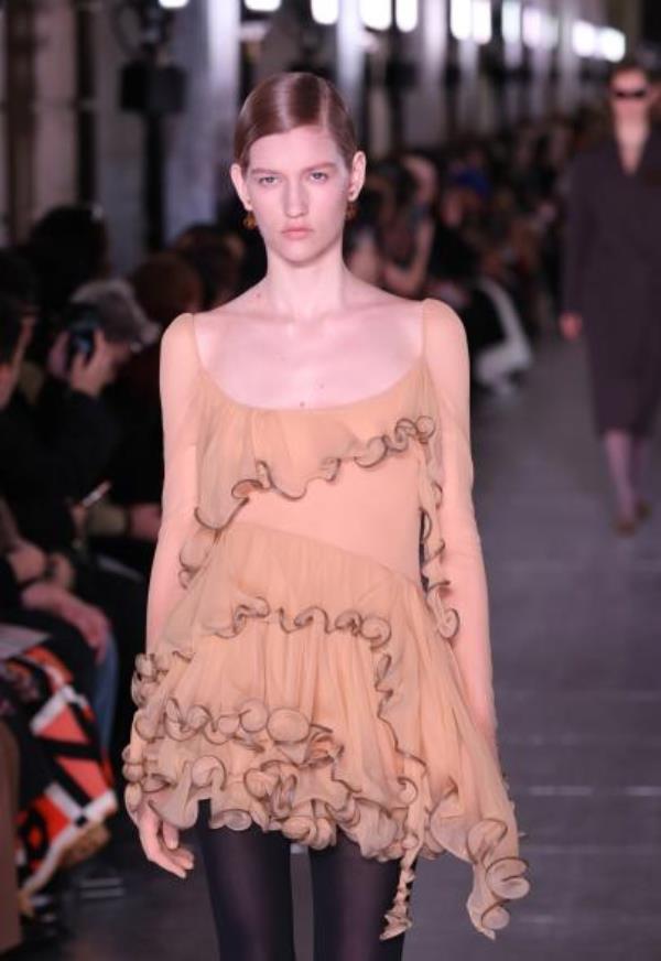 A model walks the runway wearing a dress during Tory Burch Fall/Winter 2024 New York Fashion Week at New York Public Library.