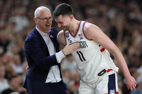 Head coach Dan Hurley and basketball player Alex Karaban #11 hugging and celebrating their victory in the NCAA Men's Basketball Tournament Natio<em></em>nal Championship