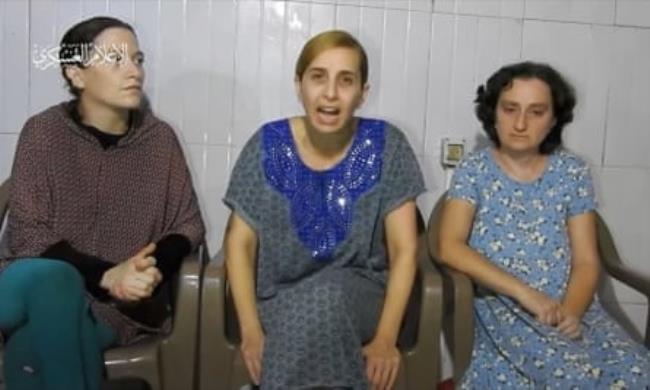 Three hostages sitting down