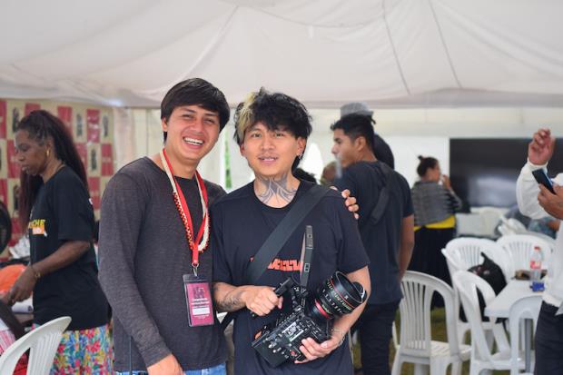 Anka, 25, of Mullu TV, assists Wakemo, 20, of NAWE (the Ecuadorian Waorani Association) in developing media skills at the BILM Co<em></em>ngress in Serena. Photo courtesy of Rebecca Wilson.