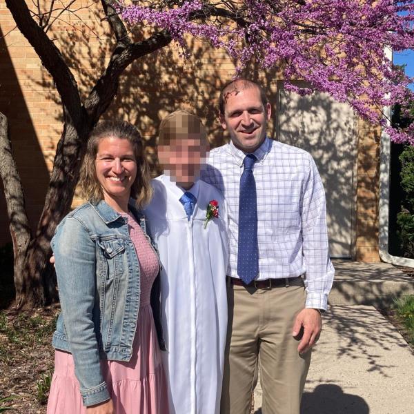 Ryan Borgwardt standing alo<em></em>ngside his wife Emily and their child