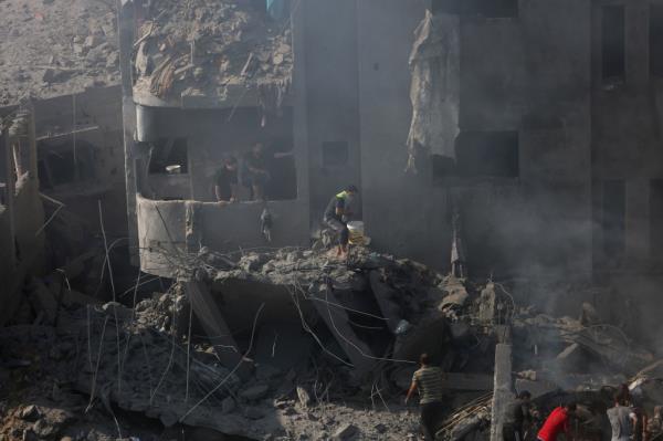 Palestinians look for survivors after an airstrike on the Bureij refugee camp in the Gaza Strip on November 2, 2023.