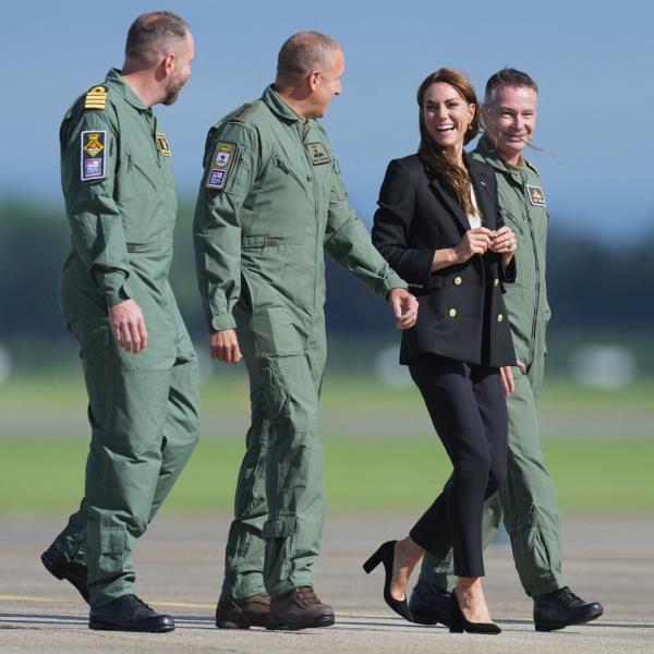 Making a grand entrance in a helicopter, Kate Middleton, 41, stepped out in a stylish black pantsuit, with a white top and matching black heels. 