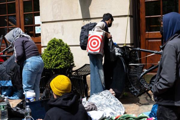 Protestors occupy space at an entrance to Hamilton Hall at Columbia University