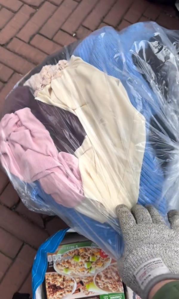 A bag of clothes found among the trash.