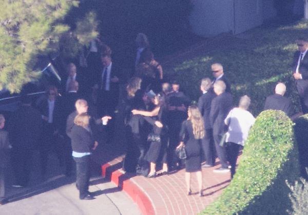 The 'Friends' cast gather with Perry’s family members in emotio<em></em>nal hugs outside of the service.