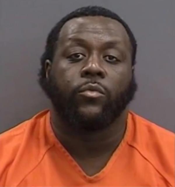 A man in an orange shirt, identified as Tristan Wright, related to a news story a<em></em>bout a violent robbery incident in Tampa, Florida