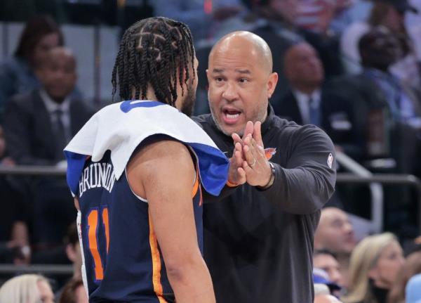 Jalen Brunson listens to instruction from assistant coach Rick Brunson, his father, during the Knicks' Game 2 win.