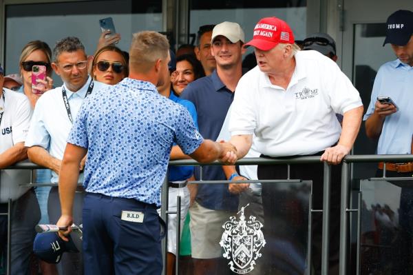 Former President Do<em></em>nald Trump shakes hands hands with Bryson DeChambeau during the 3rd round of the LIV Invitatio<em></em>nal Series Bedminster