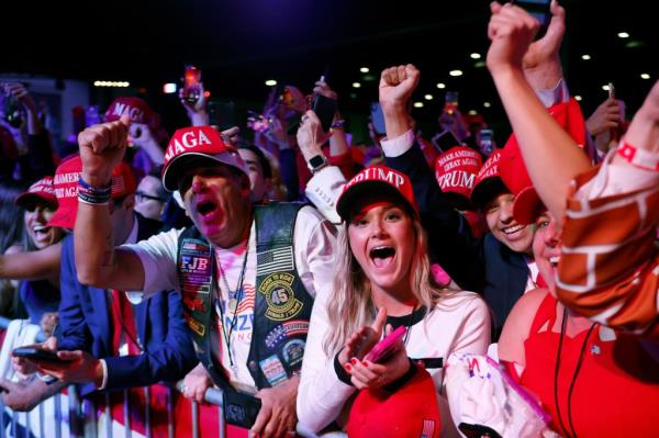 Supporters react as Fox News projects Republican presidential nominee, former U.S. President Do<em></em>nald Trump is elected president during an election night event at the Palm Beach Co<em></em>nvention Center on November 06, 2024.
