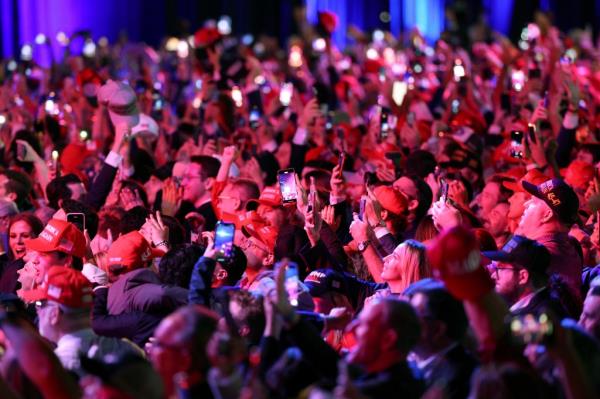 Supporters take photos as Fox News projects Republican presidential nominee, former U.S. President Do<em></em>nald Trump is elected president during an election night event at the Palm Beach Co<em></em>nvention Center on November 06, 2024.