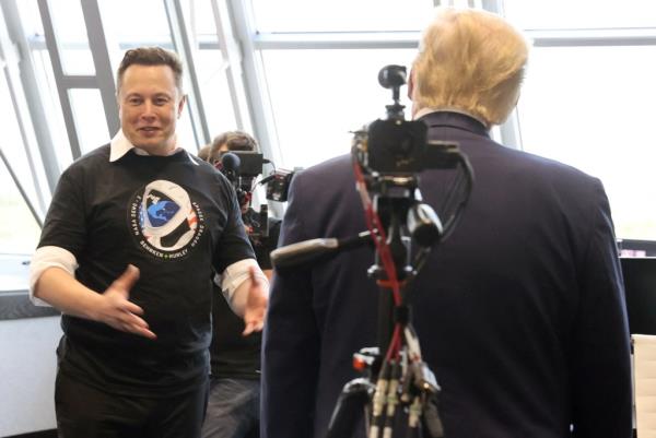 U.S. President Do<em></em>nald Trump and Elon Musk in Firing Room Four at NASA's Kennedy Space Center after the SpaceX Falcon 9 launch, discussing in front of a camera