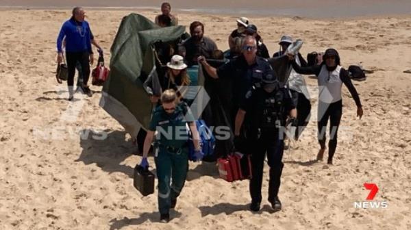The woman was treated on the beach after the shark attack before being taken to hospital