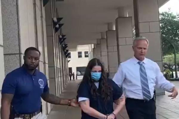 Bridgette Matthew is escorted to Metro Jail. 