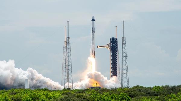 A SpaceX Falcon 9 rocket carrying the company’s Dragon spacecraft is launched on NASA’s SpaceX Crew-9 mission to the Internatio<em></em>nal Space Station with NASA astro<em></em>naut Nick Hague and Roscosmos cosmo<em></em>naut Aleksandr Gorbunov onboard, Saturday, Sept. 28, 2024, from Cape Canaveral Space Force Station in Florida. Seen from afar beyond line of trees, smoke shooting out below vessels.