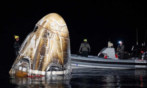 Support teams securing the SpaceX Dragon Endeavour spacecraft in the Gulf of Mexico after its return from the Internatio<em></em>nal Space Station with Expedition 70 Astro<em></em>nauts on board. The photo shows the nose of the rocket emerging from the water.