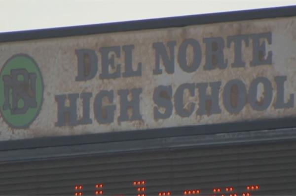 Parents hold sign protesting Poway Unified School District superintendent's alleged bullying of Del Norte High softball team.