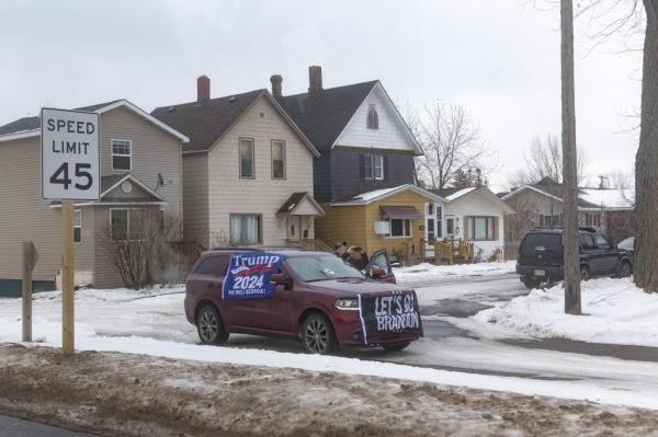 A pro-Trump supporter watches the presidential motorcade pass by in Superior, Wisconsin, U.S., January 25, 2024.